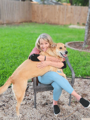 Dawn Vinson, a licensed professional counselor playing with a dog at Keller Child & Family Therapy 